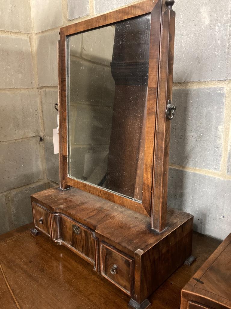 A shield-shaped mahogany toilet mirror with serpentine fronted box base and a walnut swing-frame toilet mirror, larger width 45cm, depth 22cm, height 60cm